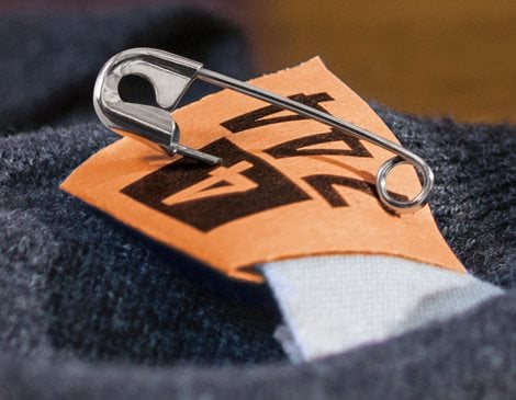 Dry Cleaning Tag with Safety Pin on Garment